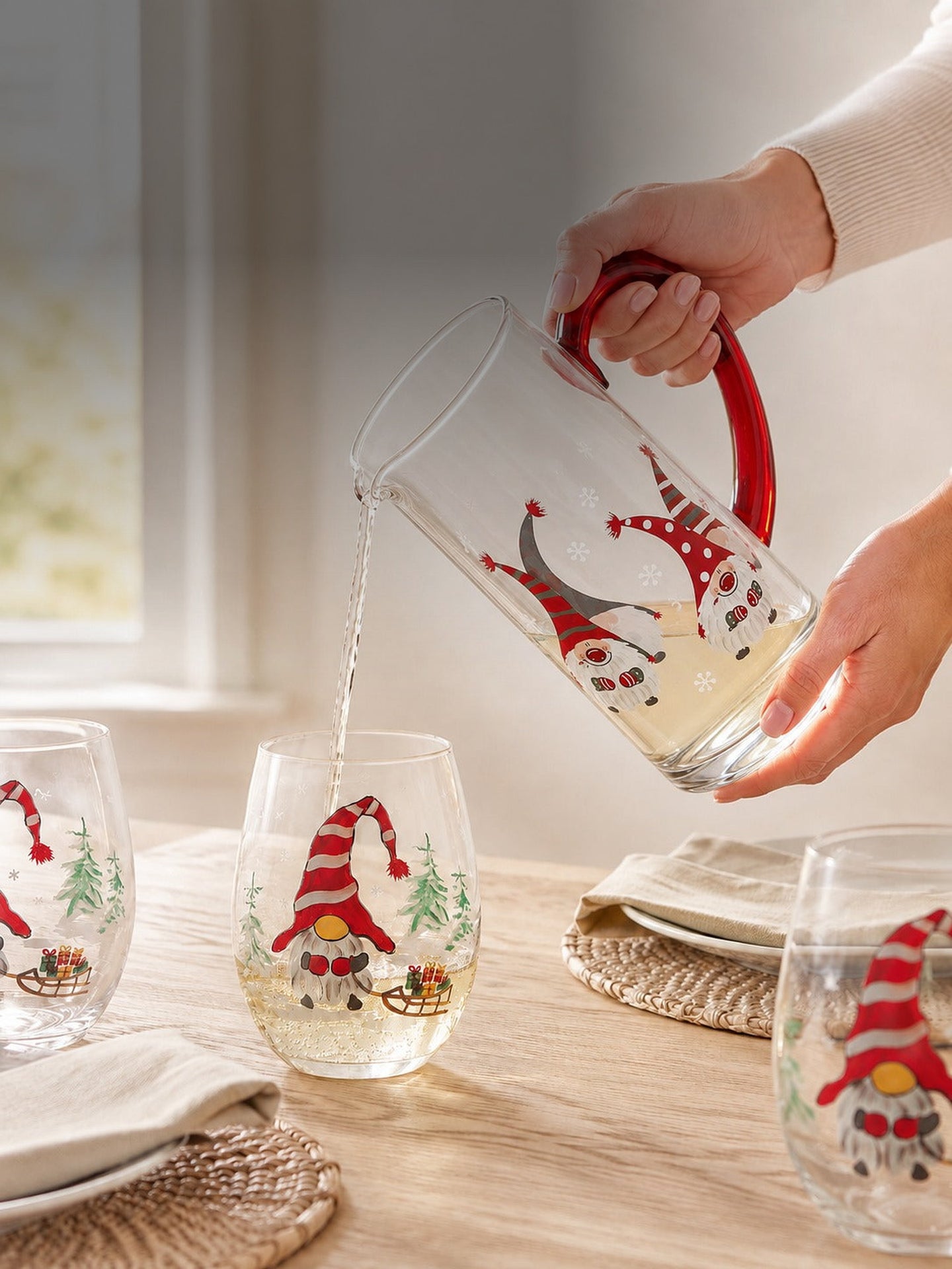Pouring from the hand-painted gnome pitcher into a gnome stemless wine glass on a sunlit table