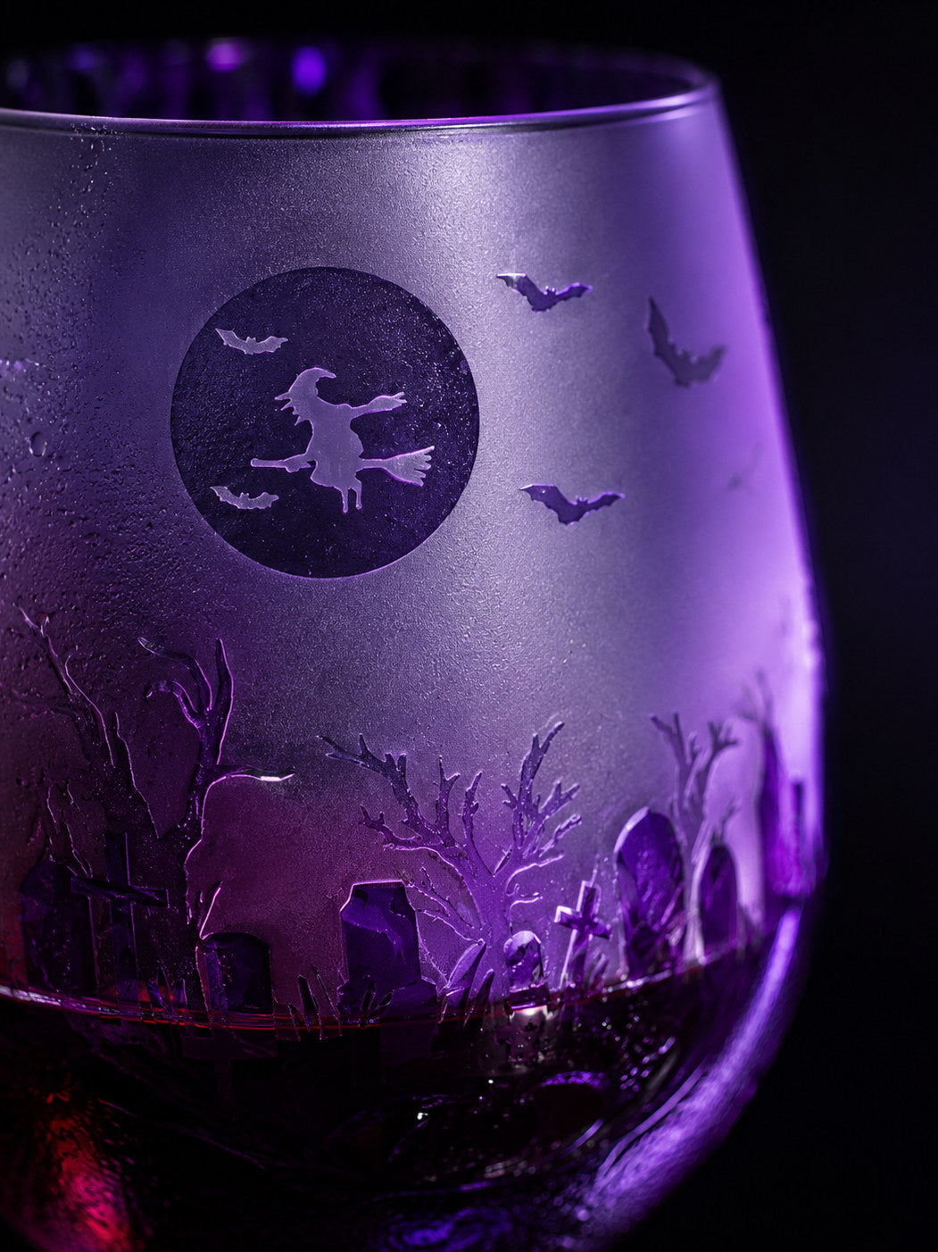 Macro of the Purple Halloween stemless glass showing the witch, bats and graveyard detail