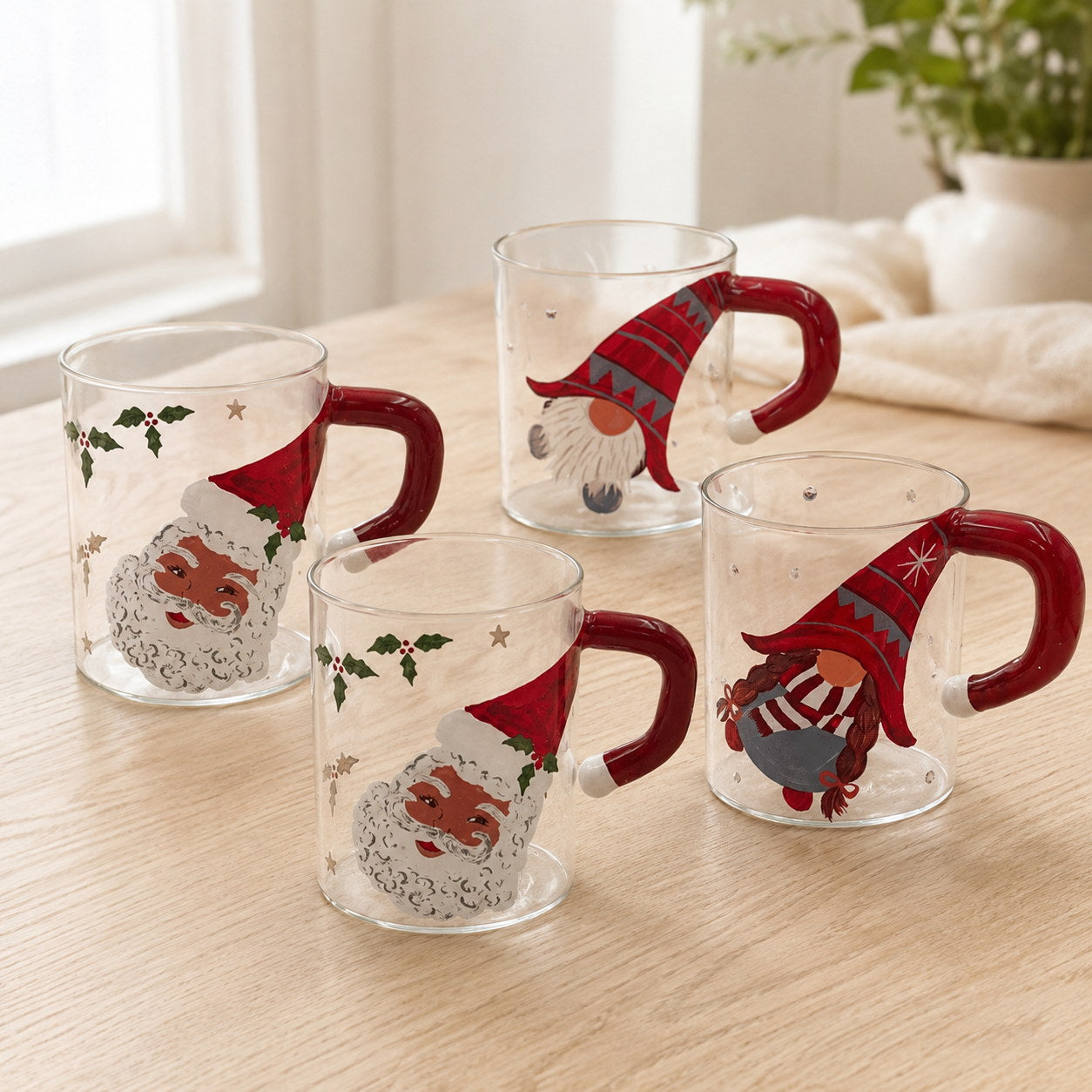 Hand-painted Santa and gnome glass Christmas mugs together on a sunlit oak table