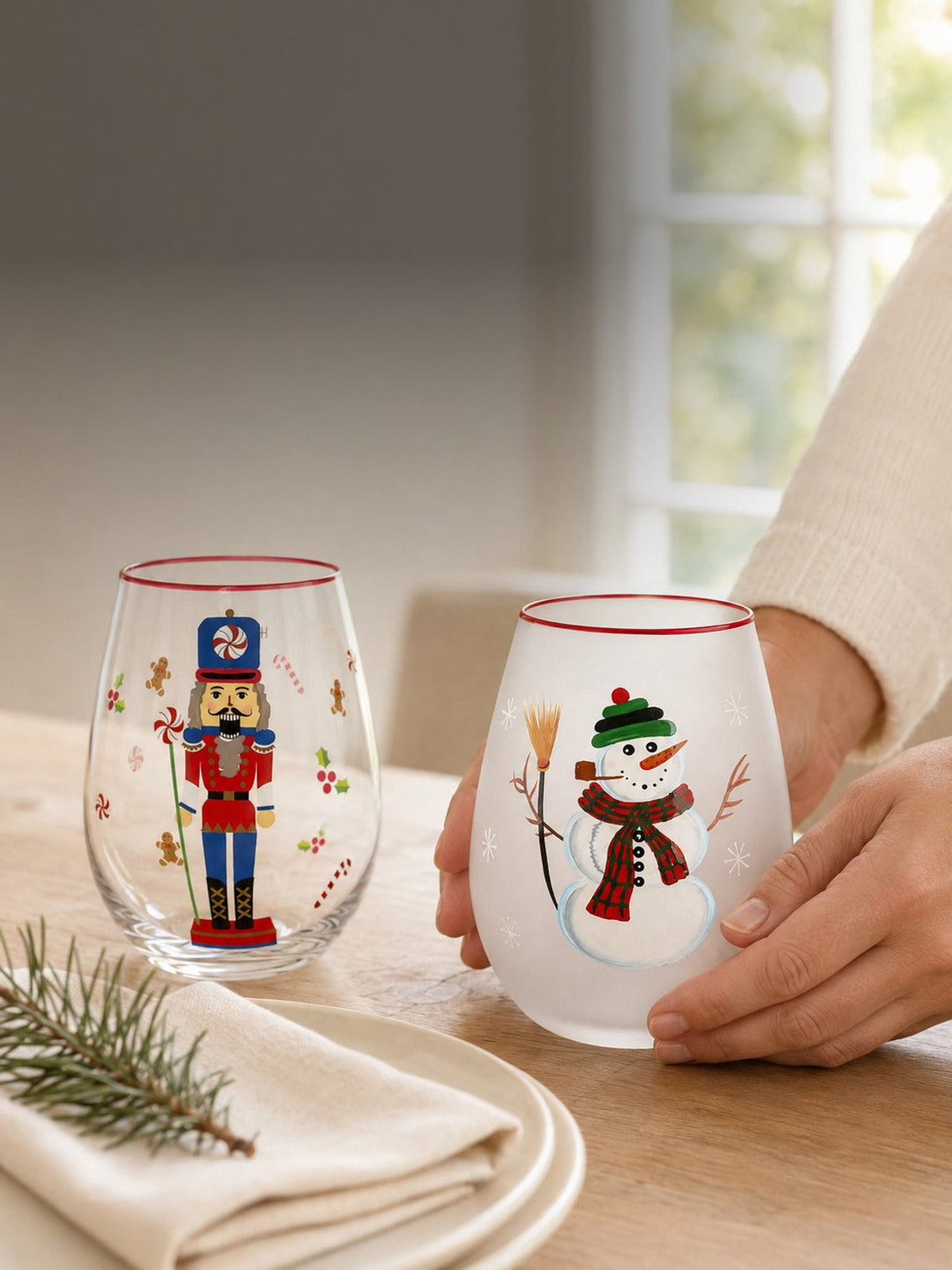 Setting a holiday table with the frosted snowman and nutcracker hand-painted stemless wine glasses