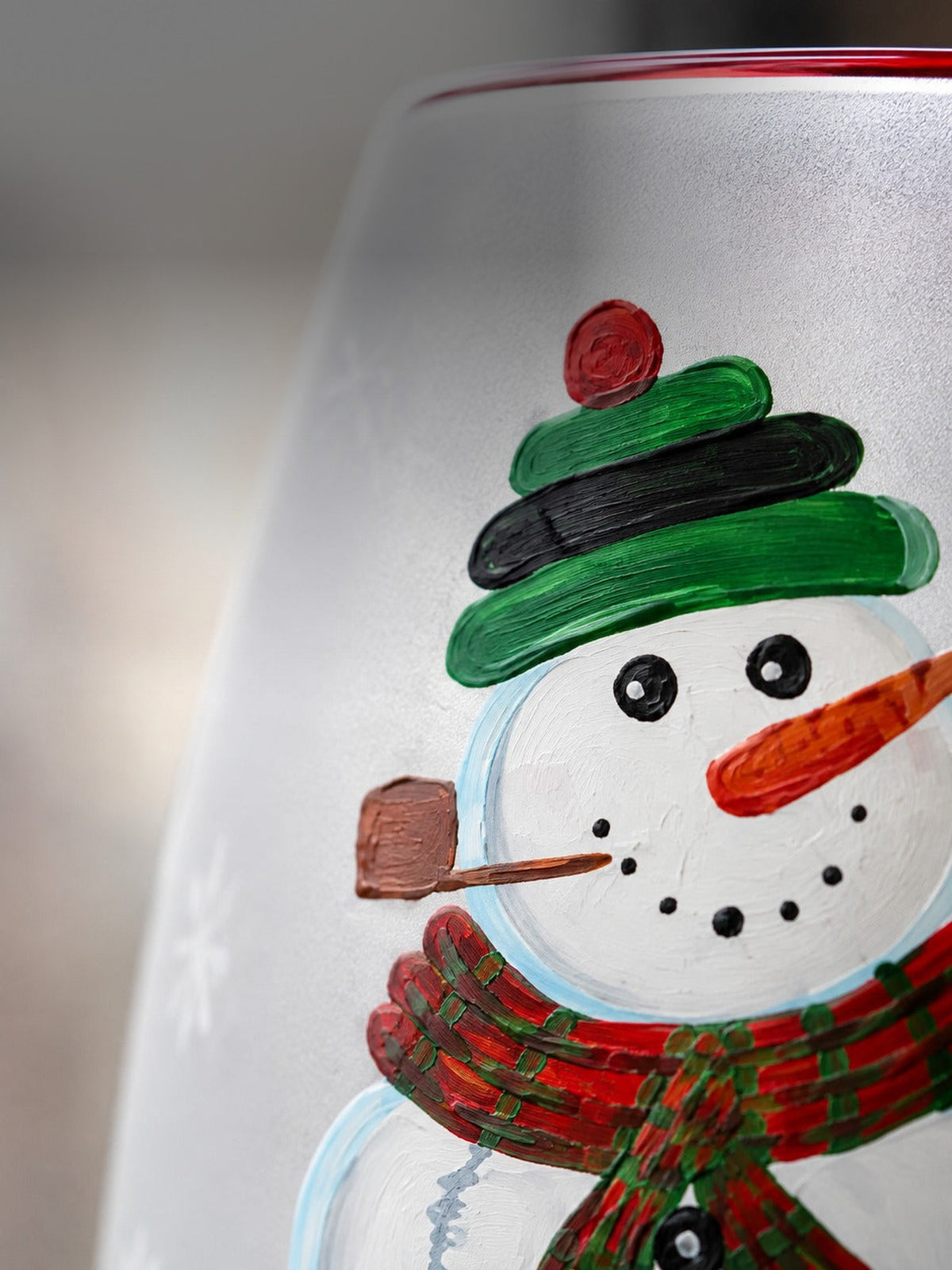 Macro detail of the hand-painted snowman on sandblasted frosted glass