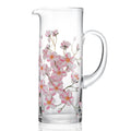 Clear glass pitcher with pink floral cherry blossom design on a white background