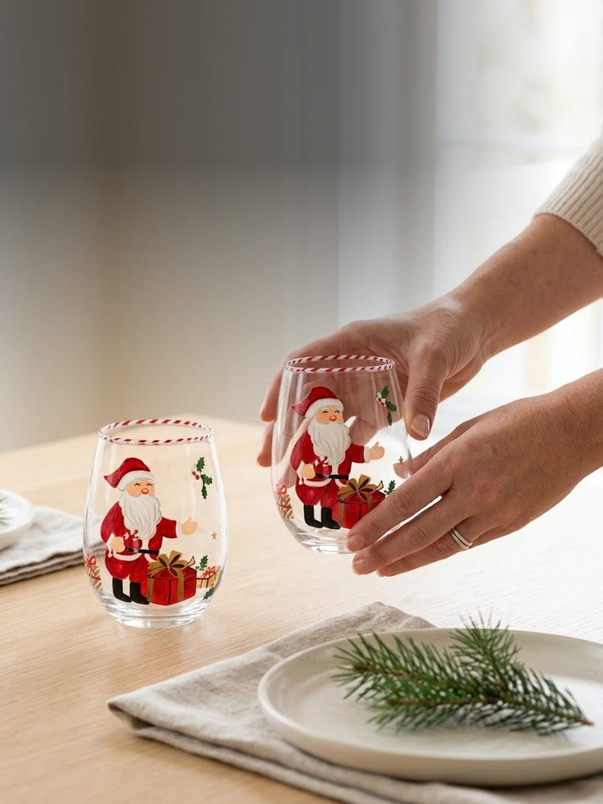 Setting a holiday table with hand-painted Santa stemless wine glasses